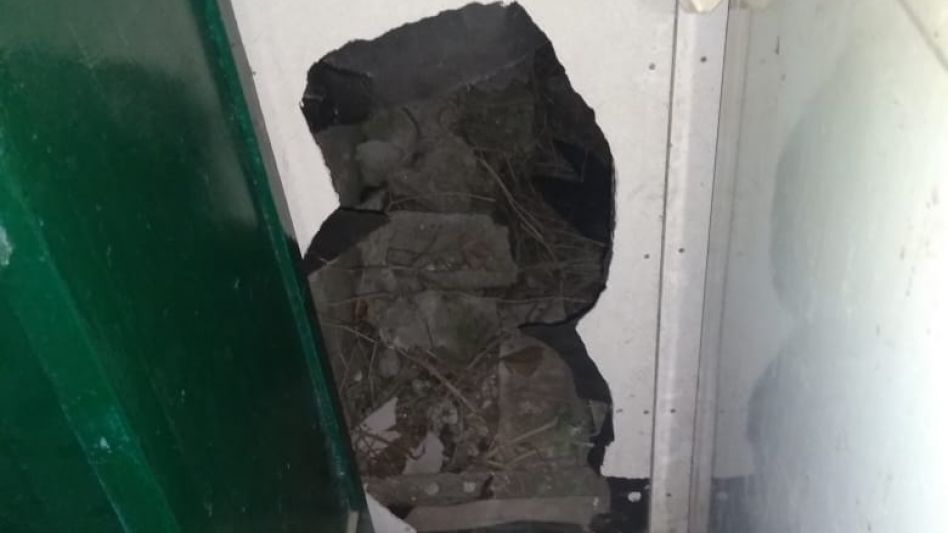 Un boquete en una pared de una casa prefabricada. Lo hicieron para ingresar a robar un televisor.