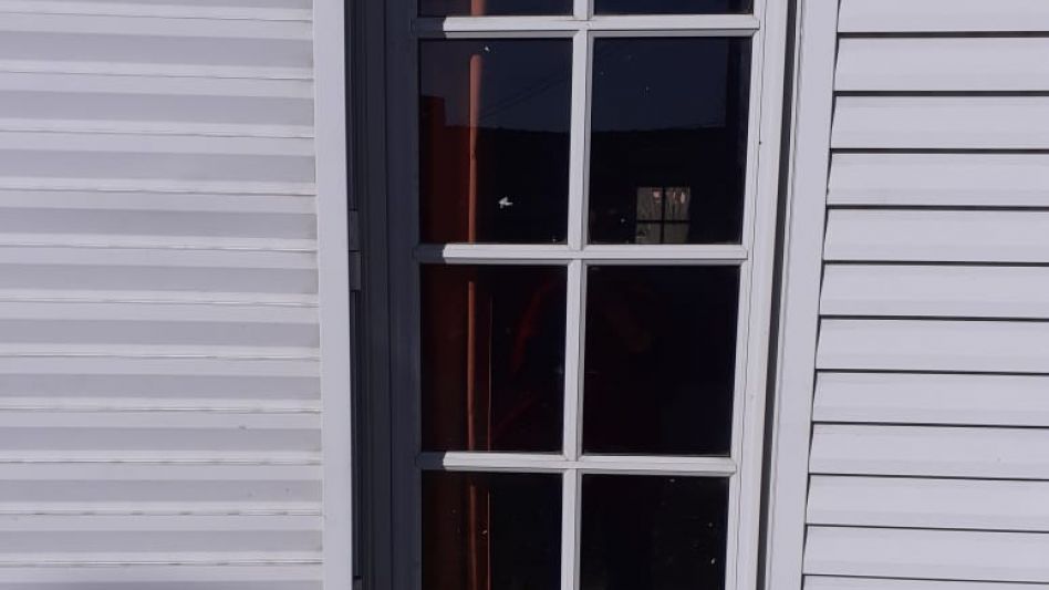 Dos ventanas de una misma casa. Por una los delincuentes entraron. Por la otra, se fueron llevándose un televisor, un horno microondas y una cuchilla.