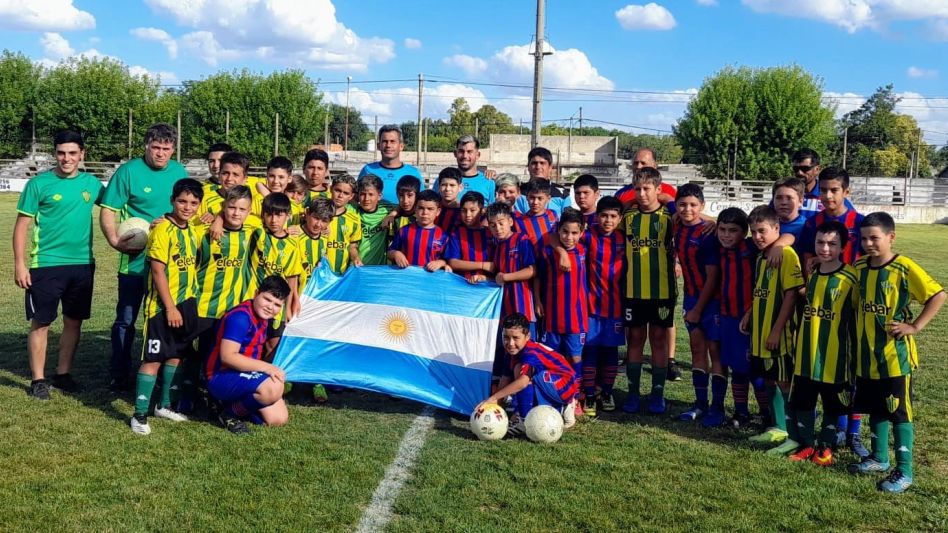 Los equipos del industrial y del ?Santo? en la Sub 12 posaron juntos con una bandera argentina. Foto: PRENSA TORNEO NOCTURNO. 